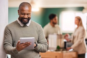 black-man-scroll-tablet-and-smile-at-startup-dig-2025-04-06-11-42-55-utc